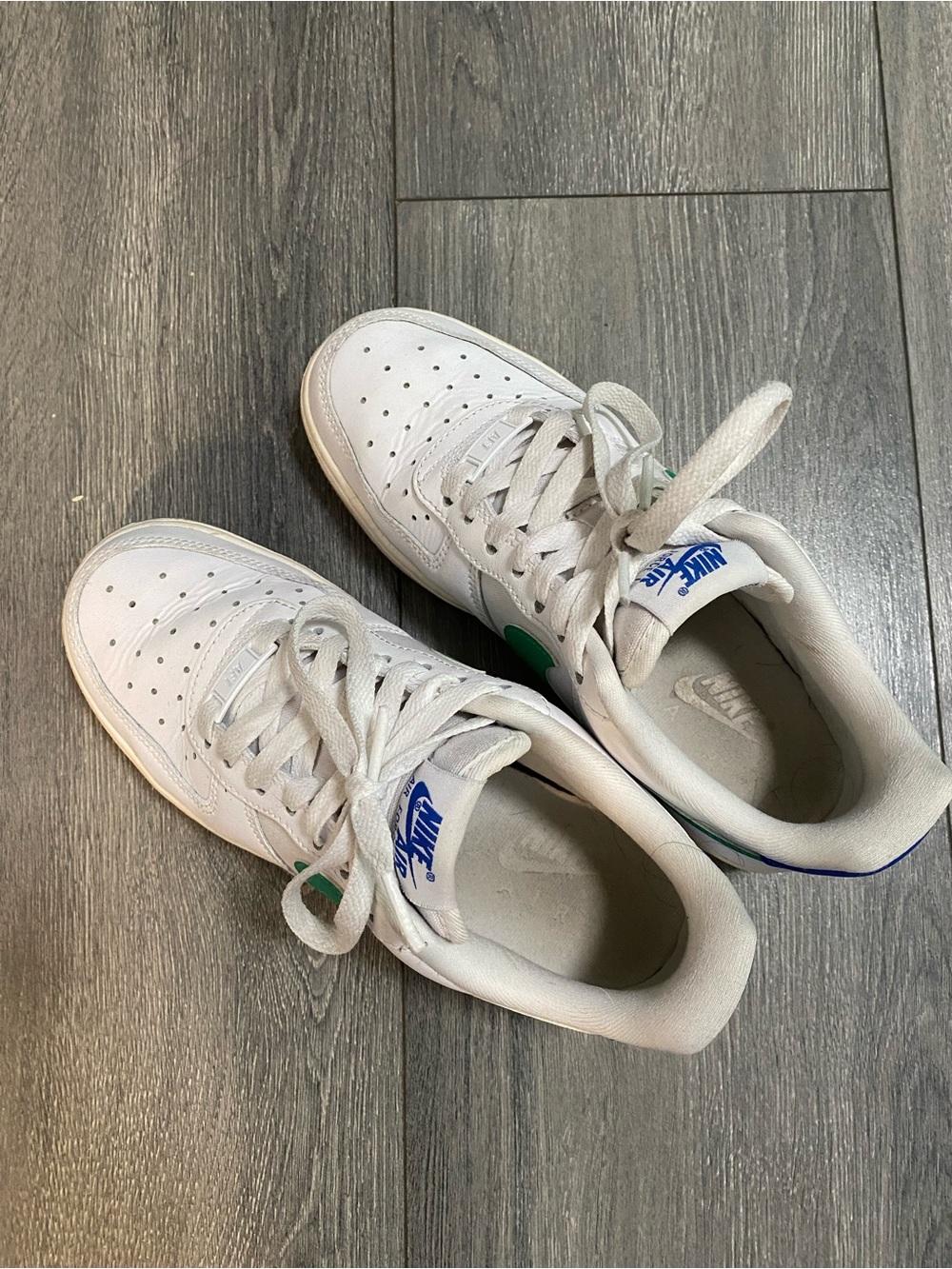 Nike White Leather Low-Top Sneakers with Green Swoosh and Blue Tongue Logo